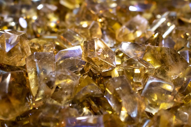 A detailed close-up of shining citrine crystals, capturing their vibrant yellow hues.