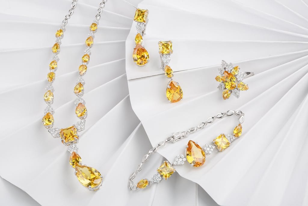 A luxurious jewelry set featuring citrine and diamond pieces, elegantly displayed with a bright and sparkling aesthetic.
