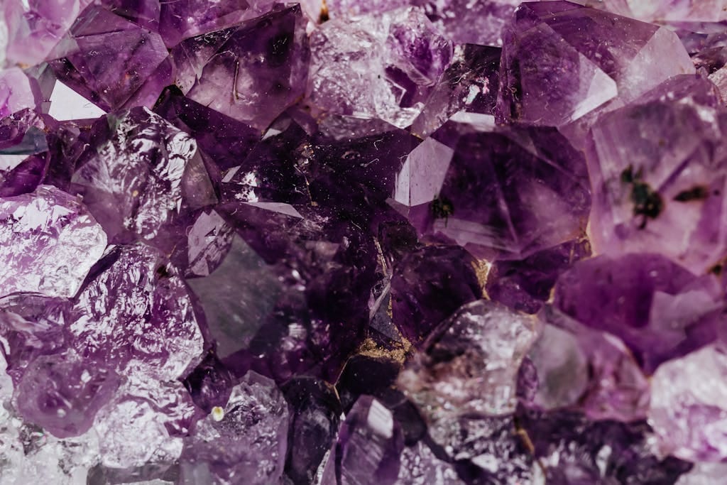 Macro shot of natural purple amethyst crystals showcasing their vibrant hues and intricate formations.